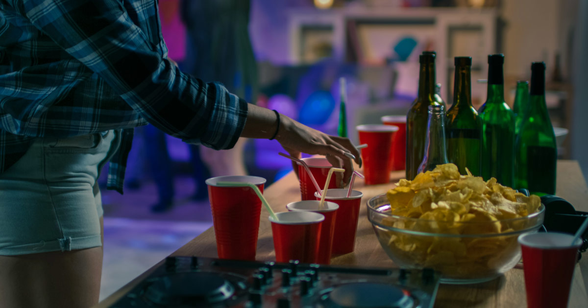 Woman having a drink at local college party