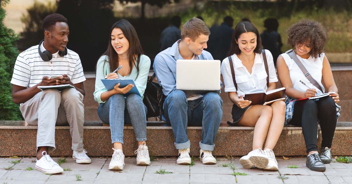 Group of College Kids Sitting Down Outdoors