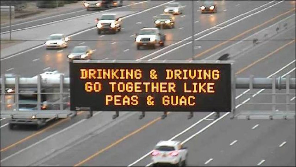 ADOT freeway sign that says, "Drinking & driving go together like peas & guac"