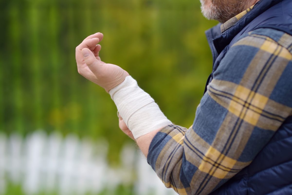 man in blue flannel with a bandage on his wrist from a personal injury