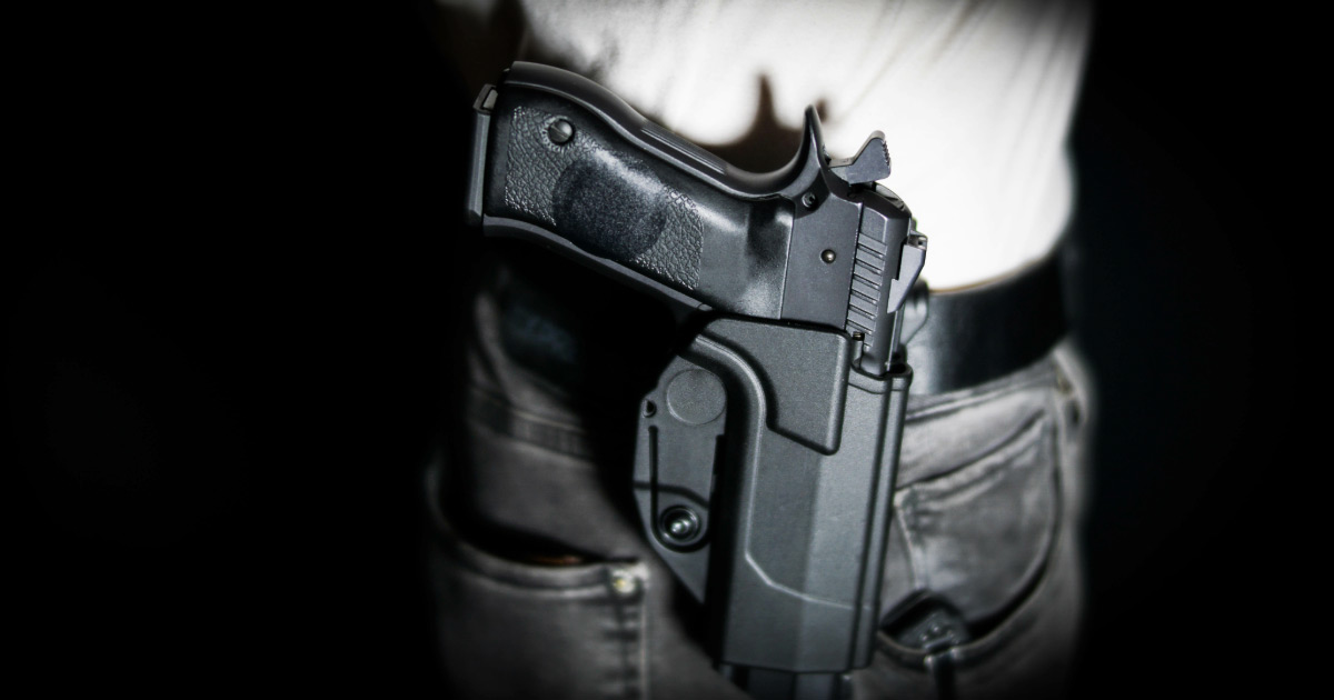 Man open carrying handgun on his hip