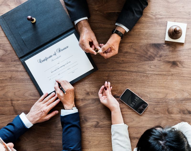 A couple with a divorce certification meeting with a lawyer