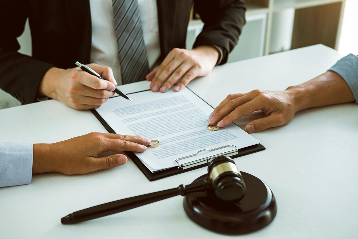 Lawyer Signing Divorce Papers with Client