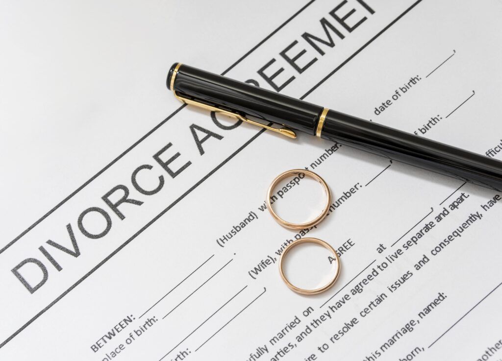 Divorce paperwork with wedding bands