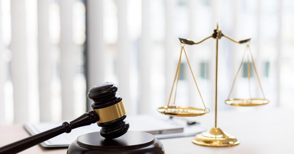 Gavel and Scales of Justice Sitting on Judge's Desk