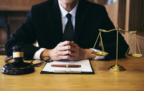 lawyer sitting at desk with hands