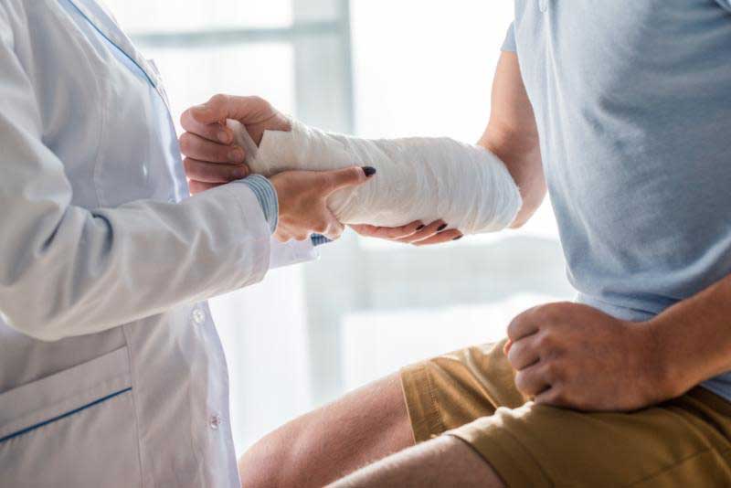 Doctor Holding Patient's Injured Arm