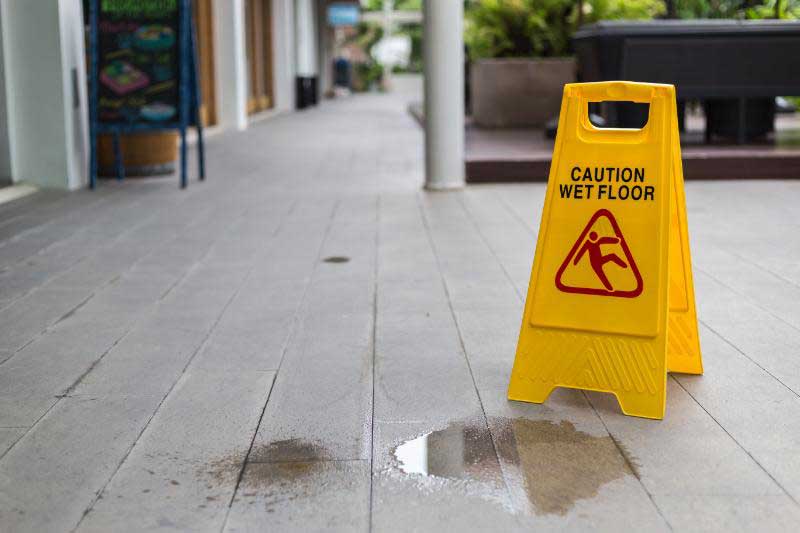 Caution Wet Floor Sign Next to Water