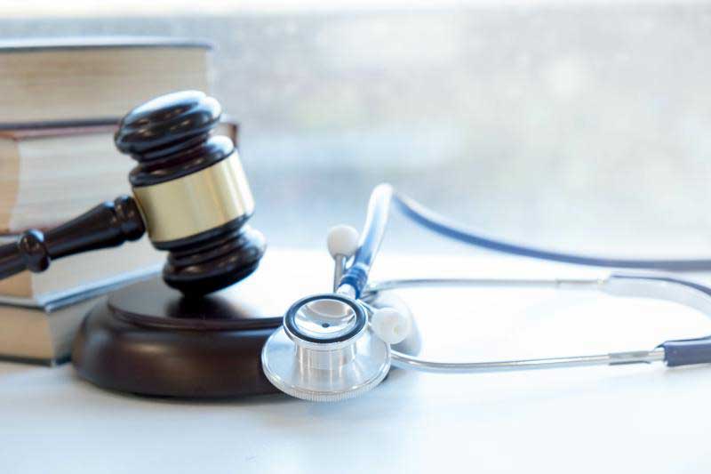 Gavel and Books Next to Stethoscope