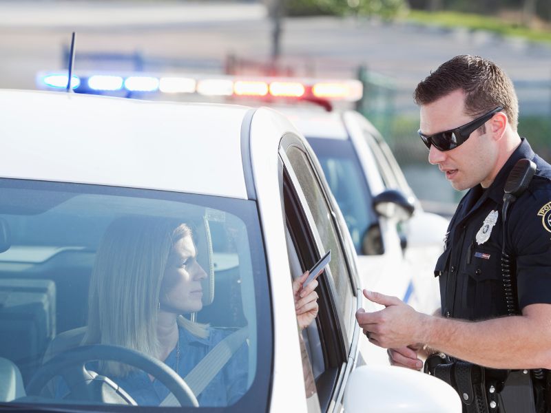 Woman pulled over by cop handing over license