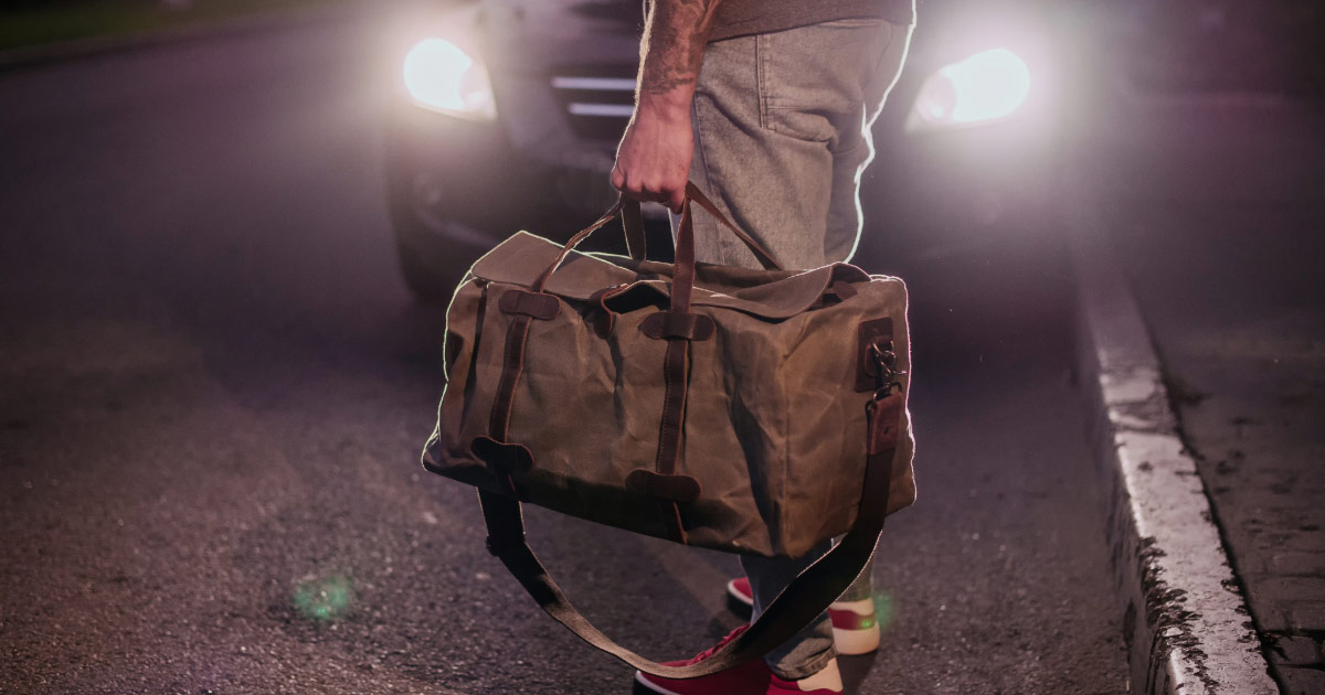 Man carrying a duffle bag full of drugs