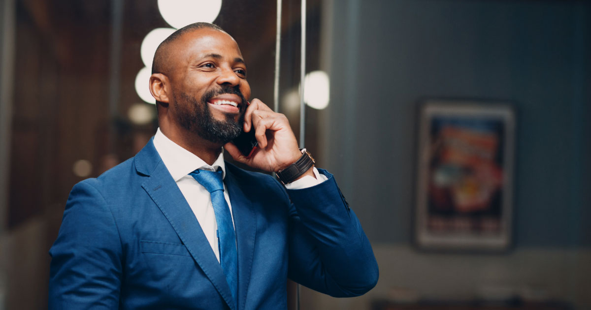 Man in a suit talking to someone on the phone