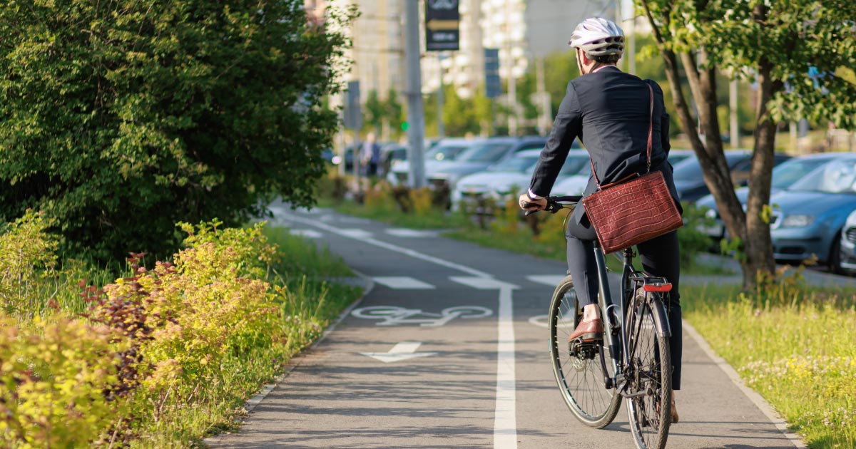 Man wearing safety helmet while bike riding on path