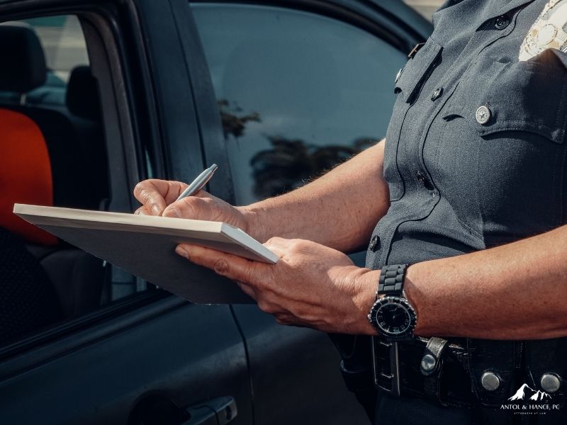 Police officer writing a criminal traffic ticket in Arizona