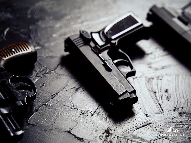 types of guns laid out on table